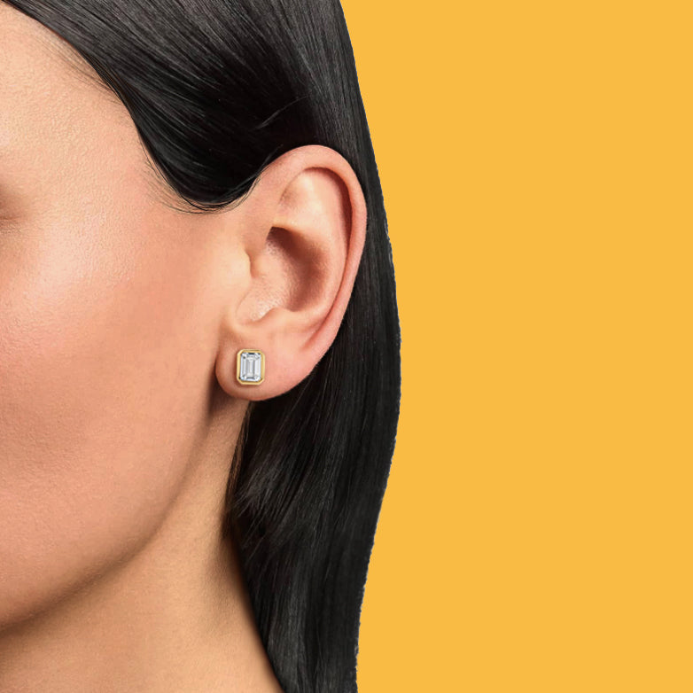 Petite Frites Straight Up earrings in yellow gold with diamonds shown on a close up image on model