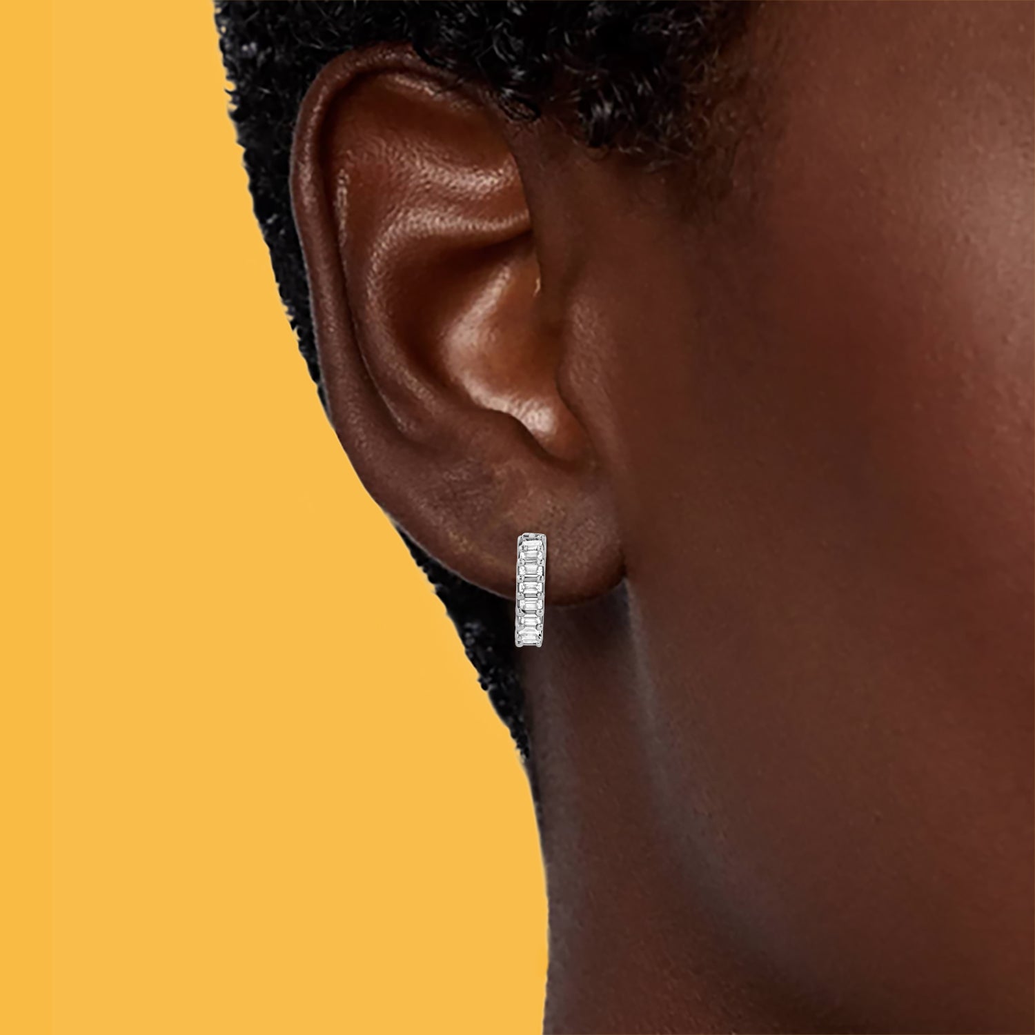 Petite Frites Candlelight earrings in white gold with diamonds shown on a close up image on model