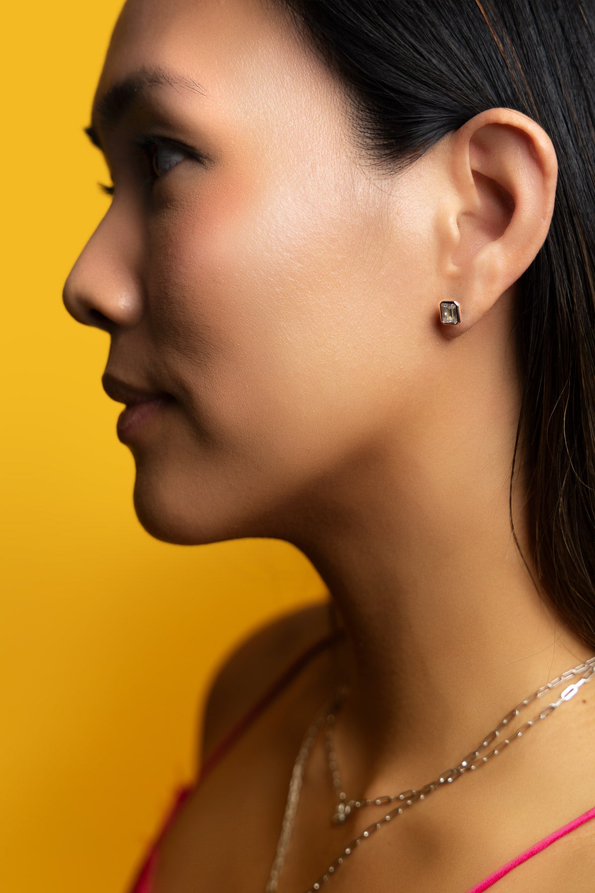 Petite Frites Straight Up earrings in yellow gold with diamonds shown on a close up image on model
