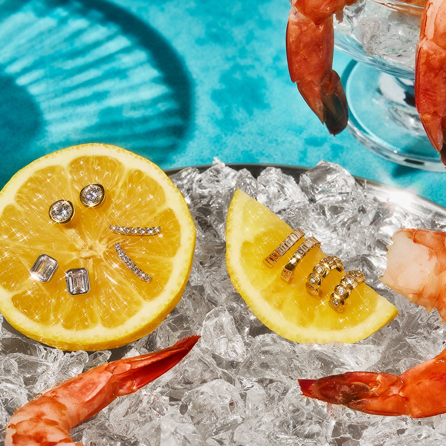 Petite Frites diamond earrings creatively styled on lemon wedges and shrimp cocktail on ice against a vibrant turquoise backdrop, blending sophistication with whimsy