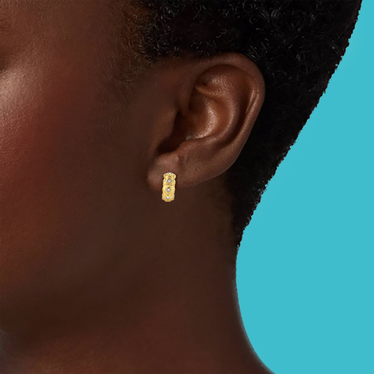Petite Frites dinner mint earrings in yellow gold with diamonds shown on a close up image on model